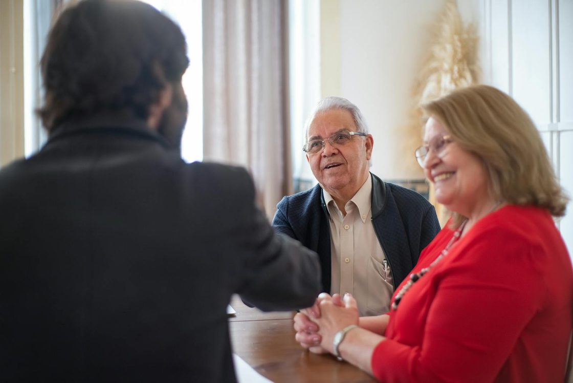 A financial coach meeting with an older couple