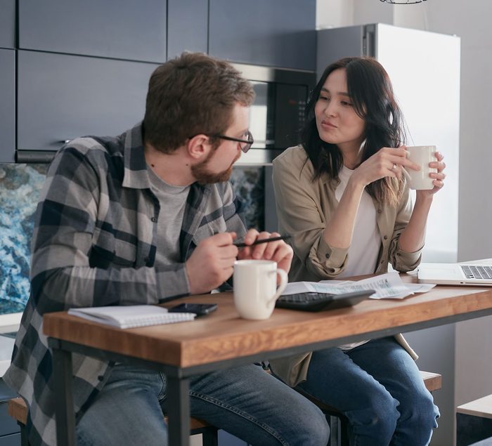 A couple working through their budget together at home